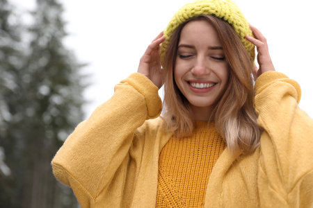 Young woman in warm clothes outdoors. winter holidaysの写真素材