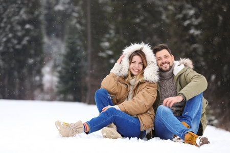 Couple spending time outdoors on snowy day. winter holidaysの写真素材