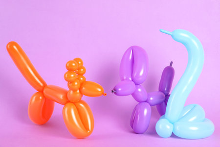 Animal figures made of modeling balloons on color backgroundの写真素材