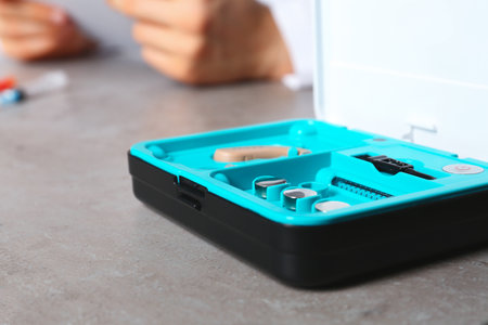Hearing aid kit on table, closeup with space for text