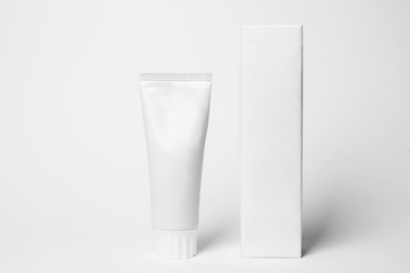 Blank tube of toothpaste and box on white backgroundの写真素材