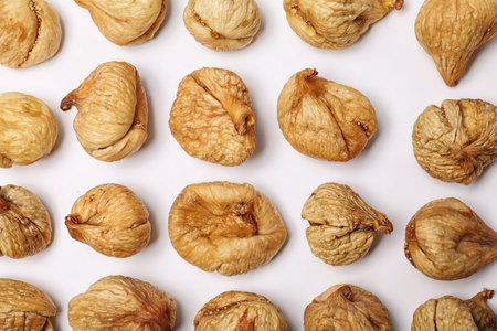 Flat lay composition with dried figs on white background. Healthy fruits