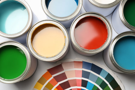 Paint cans and palette on white background, top viewの写真素材