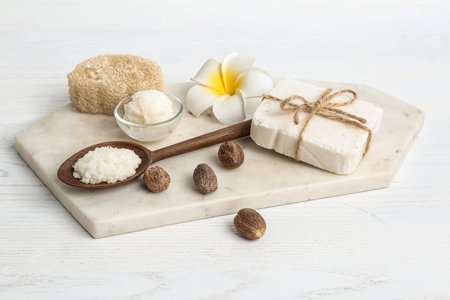 Composition with Shea butter and nuts on tableの写真素材