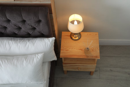 Stylish room interior with comfortable bed and nightstand, above view