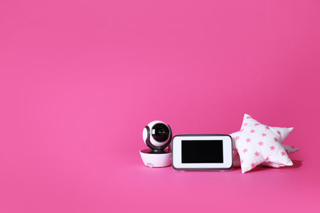 Modern CCTV security camera, monitor and soft toy on color background. Space for textの写真素材