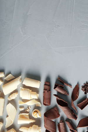 Yummy chocolate curls and space for text on gray background, top viewの写真素材