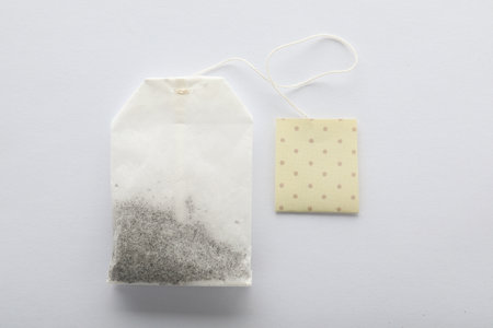 Unused tea bag with tag on white background, top view. Space for textの写真素材