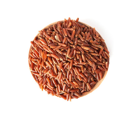 Bowl with uncooked brown rice on white background, top viewの写真素材