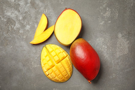 Flat lay composition with ripe mangoes on gray backgroundの写真素材