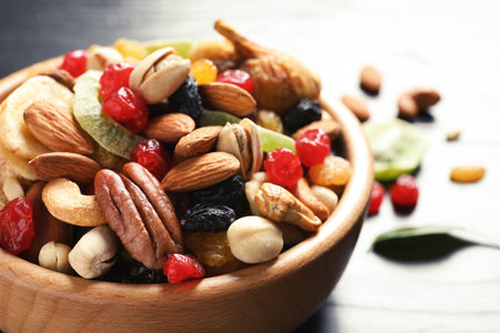 Bowl with different dried fruits and nuts on table, closeupの写真素材