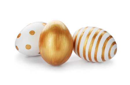 Set of traditional Easter eggs decorated with golden paint on white backgroundの写真素材