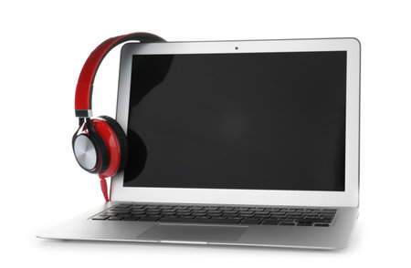 Laptop with blank screen and headphones on white backgroundの写真素材