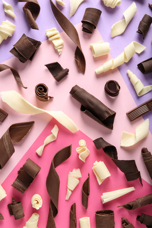 Yummy chocolate curls on color background, top viewの写真素材
