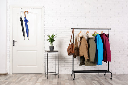 Stylish hallway interior with clothes on hanger standの写真素材