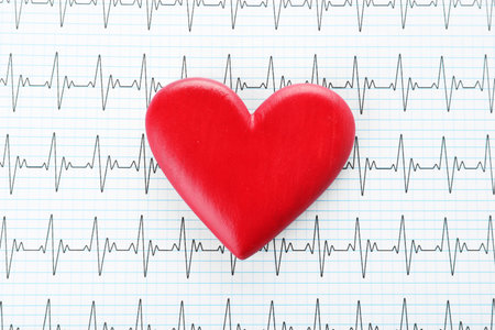 Red heart on cardiogram, top view. health careの写真素材