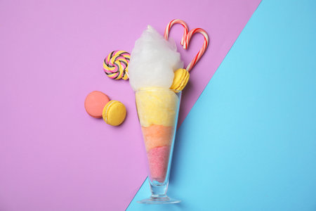 Composition with cotton candy in glass on color background, top viewの写真素材