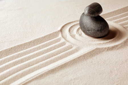 Stacked zen garden stones on sand with pattern, space for text. meditation and harmonyの写真素材