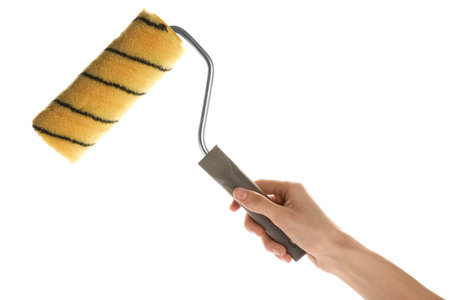 Woman holding paint roller brush on white background, closeupの写真素材