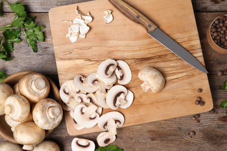 Flat lay composition with fresh champignon mushrooms on wooden tableの写真素材