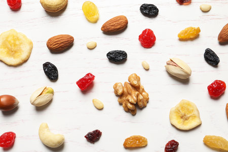 Flat lay composition of different dried fruits and nuts on wooden backgroundの写真素材