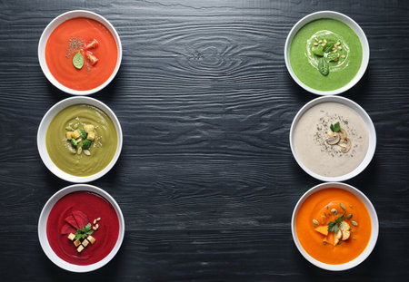 Various soups in bowls and space for text on wooden background, top view. healthy foodの写真素材