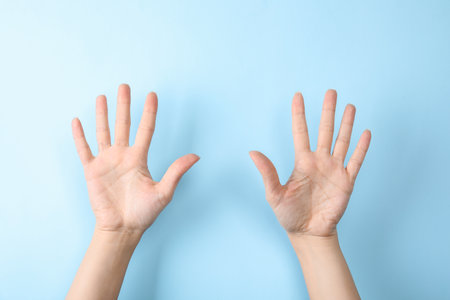 Woman showing sign ten on color background, closeup. body languageの写真素材