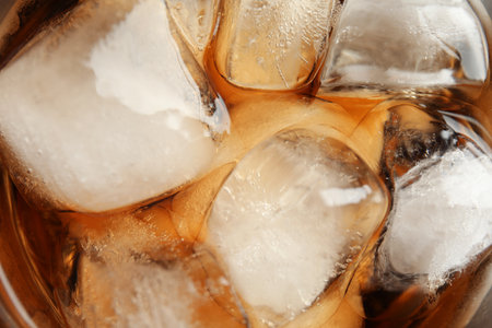 Closeup view of tasty refreshing cola with ice cubes as backgroundの写真素材