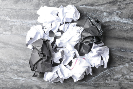 Pile of crumpled paper on gray background, top view. recycling problemの写真素材