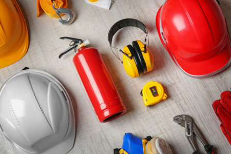 Flat lay composition with tools and safety equipment on wooden backgroundの写真素材