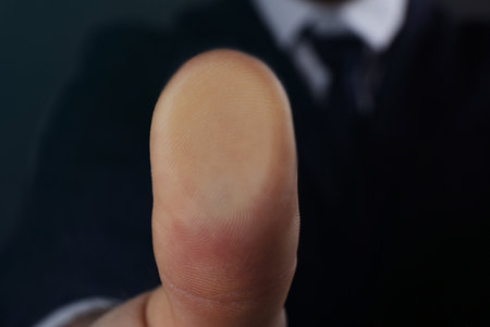 Businessman pressing control glass of biometric fingerprint scanner, closeup. Space for textの写真素材
