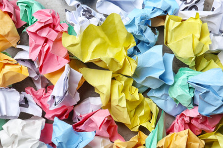 Pile of crumpled paper on gray background, top view. recycling problem