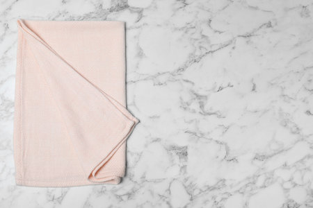 Fabric napkin and space for text on marble background, top viewの写真素材