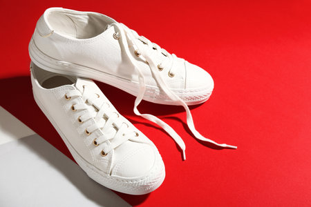 Pair of stylish sneakers on color background, space for textの写真素材