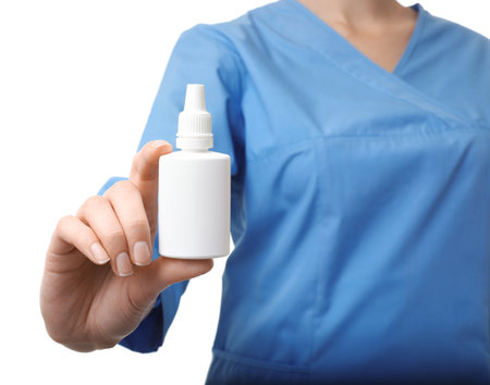 Female doctor holding plastic bottle with medicine on white background, closeup. medical objectの写真素材