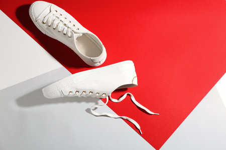 Pair of stylish sneakers on color background, top view with space for textの写真素材