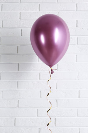 Bright balloon near brick wall. party timeの写真素材