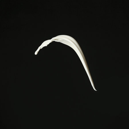 Splash of fresh milk on black backgroundの写真素材