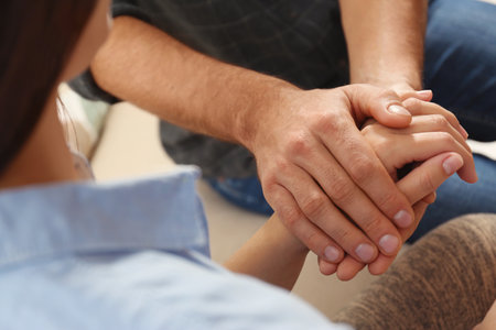 Man comforting woman, closeup of hands. Help and support conceptの写真素材