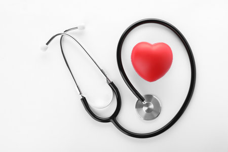 Stethoscope and red heart on white background, top viewの写真素材
