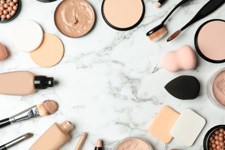 Flat lay composition with skin foundation, powder and beauty accessories on marble background. Space for textの写真素材