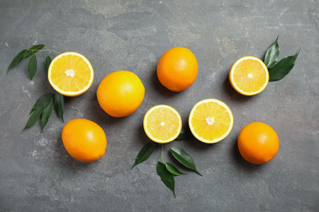 Flat lay composition with fresh oranges on gray backgroundの写真素材