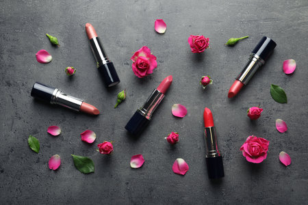 Flat lay composition with lipsticks and roses on gray backgroundの写真素材