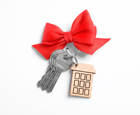 House keys with trinket and bow on white background, top viewの写真素材