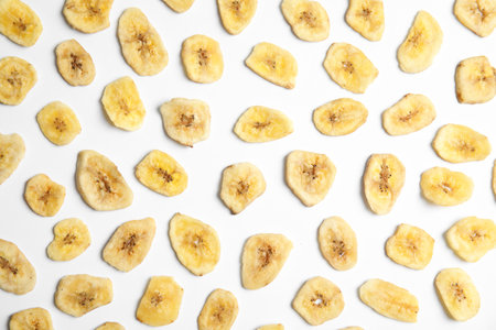 Flat lay composition with banana slices on white background. Dried fruit as a healthy snackの写真素材