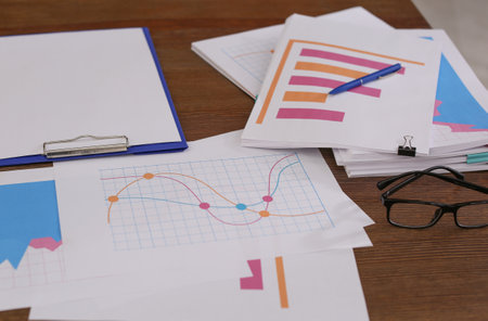 Messy pile of documents on wooden tableの写真素材