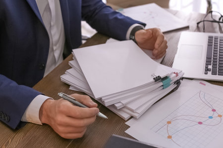 Businessman working with documents at office table, closeup. Space for textの写真素材