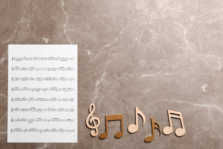 Sheet and music notes on color background, top view. Space for textの写真素材