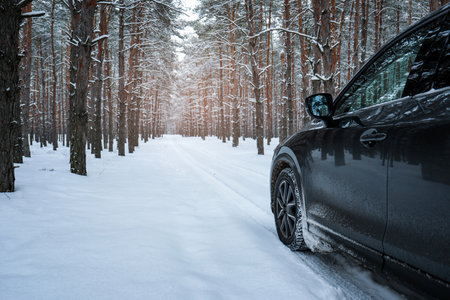 Snowy country road with car on winter day. Space for text