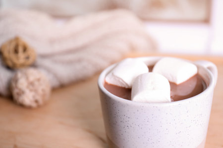 Cup of aromatic cacao with marshmallows on blurred background, closeup. Space for textの写真素材